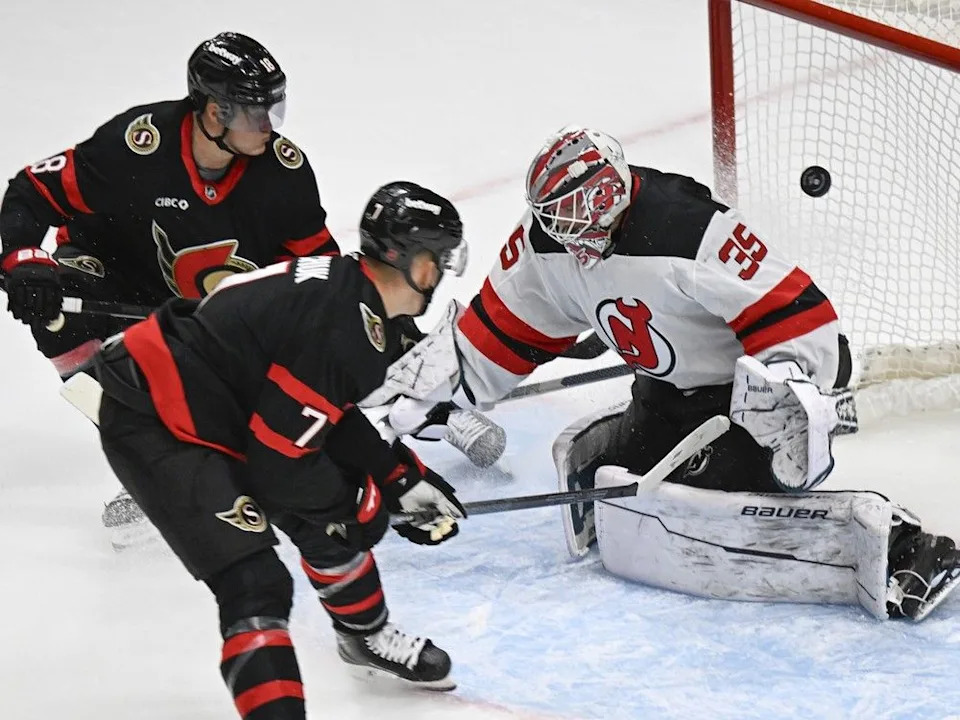 Ottawa Senators captain Brady Tkachuk shoots over New Jersey Devils goalie Georgi Romanov’s net during second-period action at the Videotron Centre in Quebec City, Sunday, Sept. 28, 2025. The Senators’ Tim Stutzle, behind, looks on.