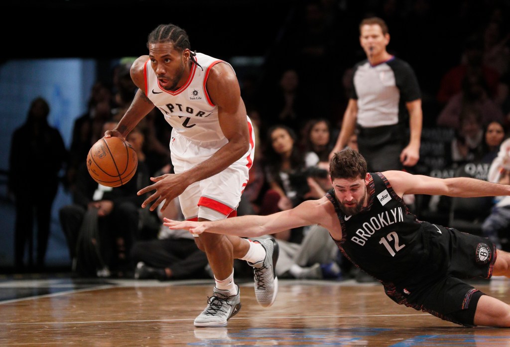 Joe Harris #12 of the Brooklyn Nets looses the ball to Kawhi Leonard #2 of the Toronto Raptors during the fourth quarter as the Brooklyn Nets defeat the Toronto Raptors 106-105 in an NBA basketball game at Barclays Center on  December 7, 2018  