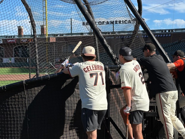 The San Jose Sharks Macklin Celebrini, left, and Will Smith talk to Giants hitting coach behind the batting cage at Oracle Park on Monday, September 8, 2025. (Evan Webeck / Bay Area News Group)