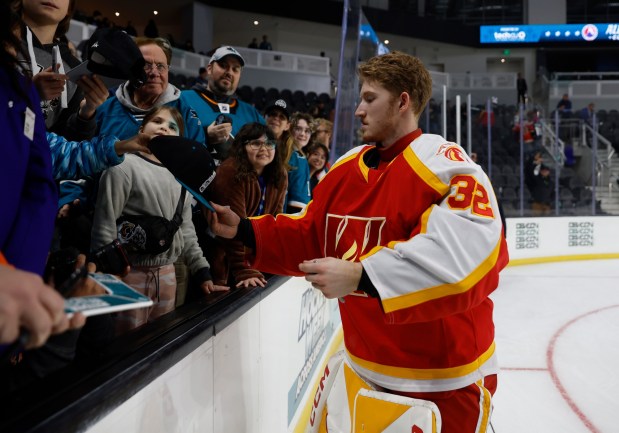 Pacific Division All-Stars goaltender Dustin Wolf (32), from the Calgary Wranglers, signs autographs after the 2024 AHL All-Star Classic Skills Competition at Tech CU Arena in San Jose, Calif., on Sunday, Feb. 4, 2024. (Nhat V. Meyer/Bay Area News Group)