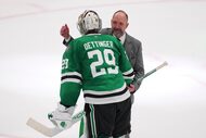 Dallas Stars goaltender Jake Oettinger (29) and head coach Pete DeBoer, rear, celebrate the...