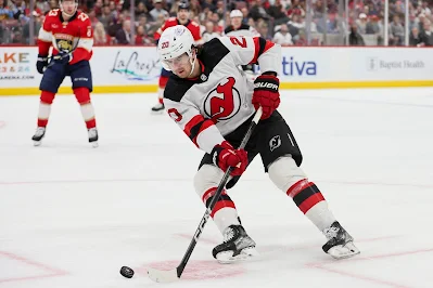 Michael McLeod, former NJ Devils forward, skates with puck