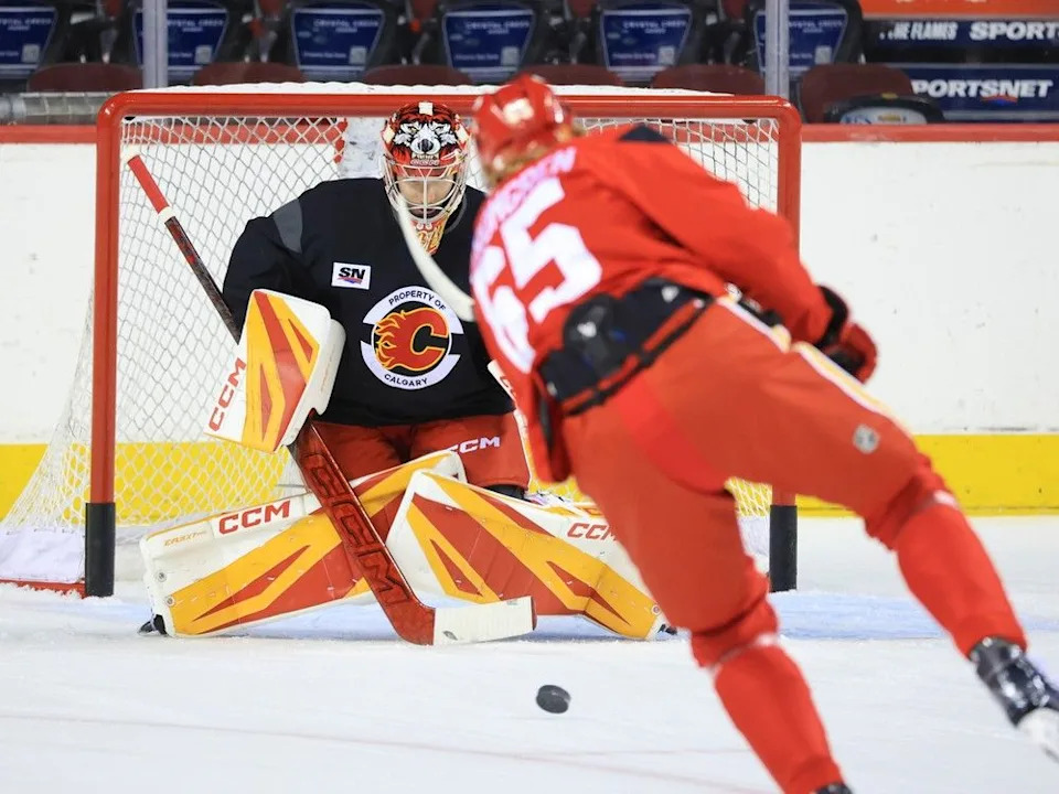  Forward William Stromgren takes a shot on goaltender Dustin Wolf during training camp.