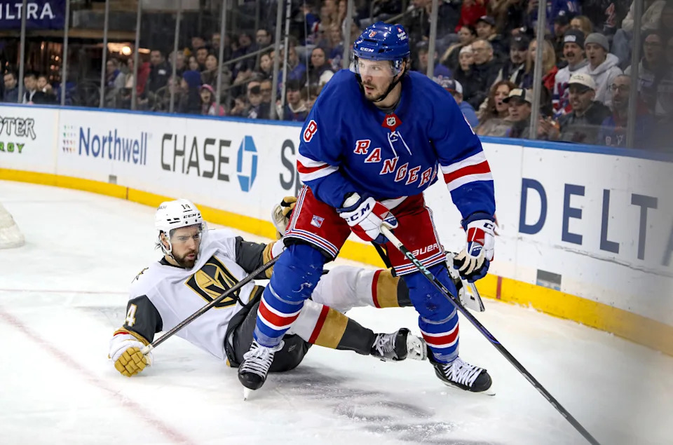 New York Rangers center J.T. Miller (8) battles for the puck in the corner in front of Vegas Golden Knights defenseman Nicolas Hague (14).Danny Wild-Imagn Images