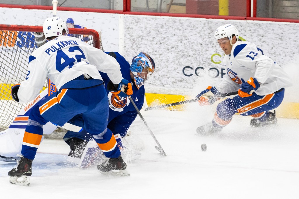 New York Islanders goalie David Rittich defends goal between Jesse Pulkkinen (42) and Mathew Barzal (13) during practice at the Northwell Health Ice Center, Thursday, Sept. 18, 2025, in East Meadow, NY.