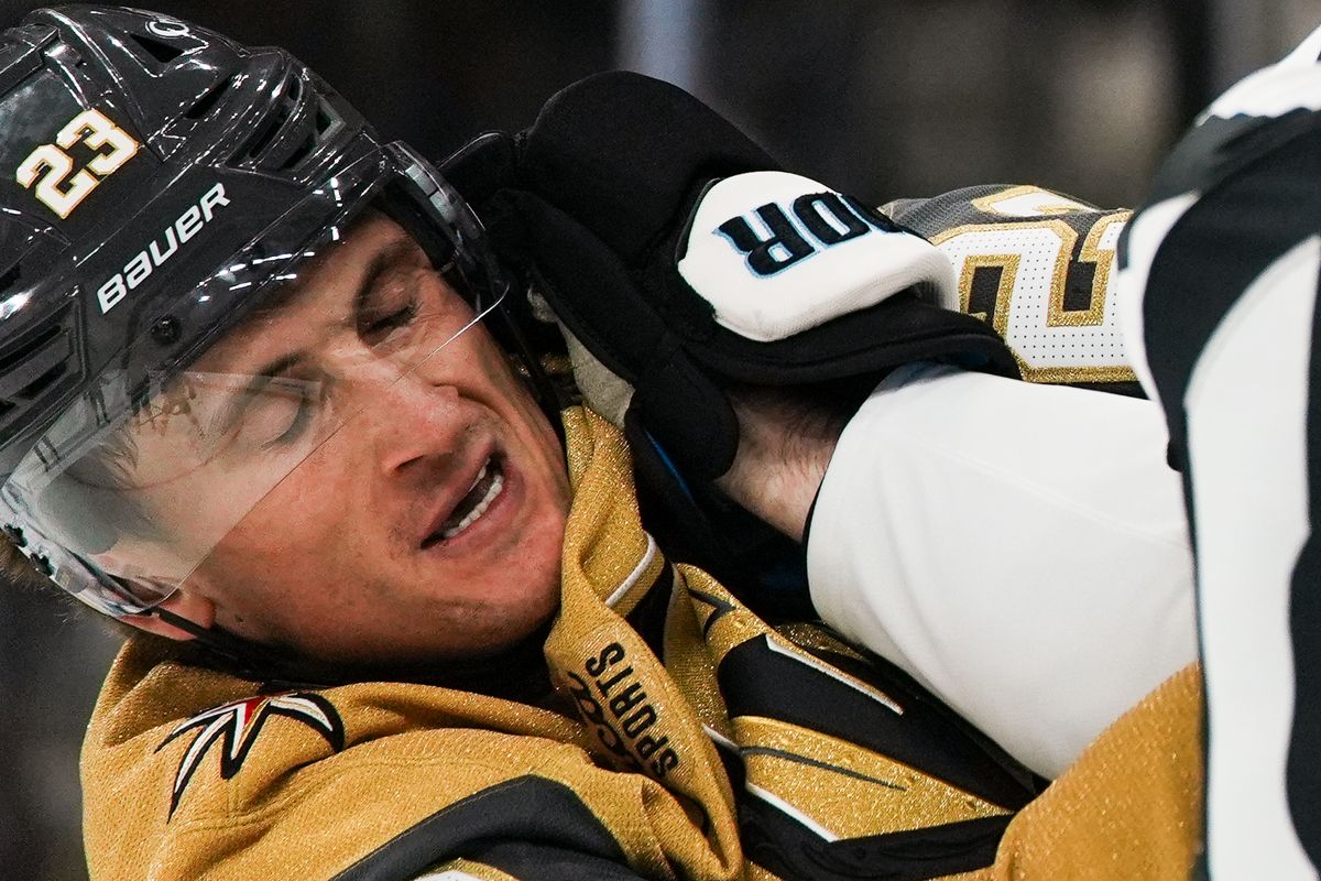 Vegas Golden Knights forward Cole Reinhardt (23) takes punch from Utah Mammoth defenseman Ian Cole (28) during first period of NHL preseason game against Utah Mammoth on Thursday, Sept. 23, 2025 in Las Vegas.