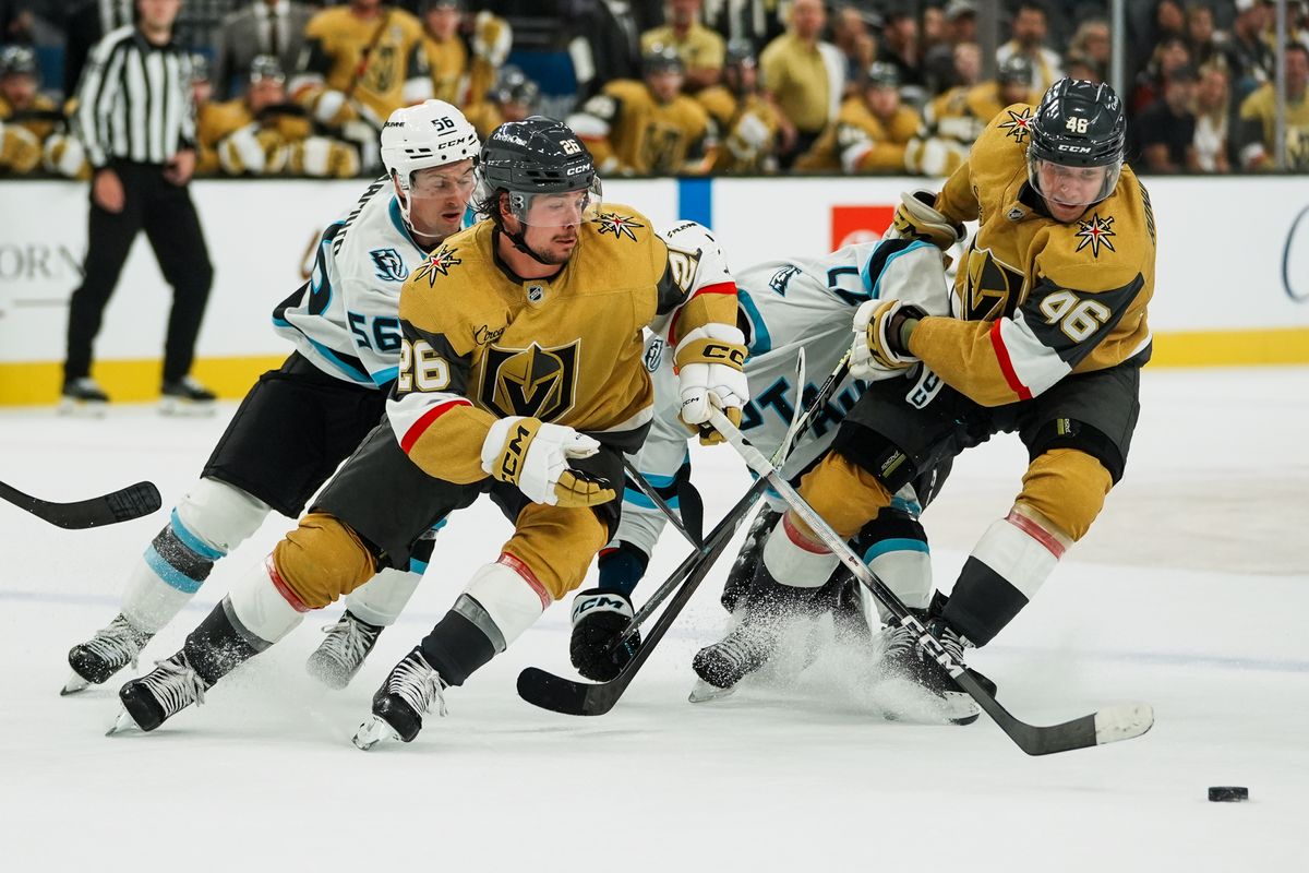 Vegas Golden Knights forward Alexander Holtz (26) and Utah Mammoth right wing Kailer Yamamoto (56) reach for control of the puck while forward Jonas Rondbjerg (46) holds back JJ Petrerka (77) during overtime of NHL preseason game against Utah Mammoth on Thursday, Sept. 23, 2025 in Las Vegas.