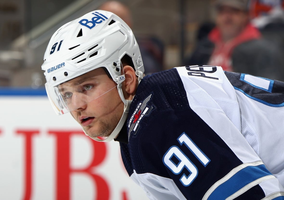 A close up of a male ice hockey player wearing number 91.