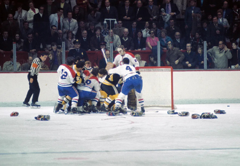 Boston Bruins and Montreal Canadiens scuffle in front of Canadiens goalie Ken Dryden.