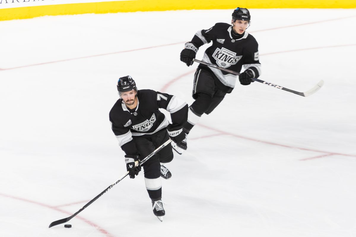 Los Angeles Kings defense Jakub Dvorak (51) and Kyle Burroughs (7) looks to pass the puck during an NHL hockey game against the Anaheim Ducks, Sunday September 21, 2025 in Ontario, Calif.
