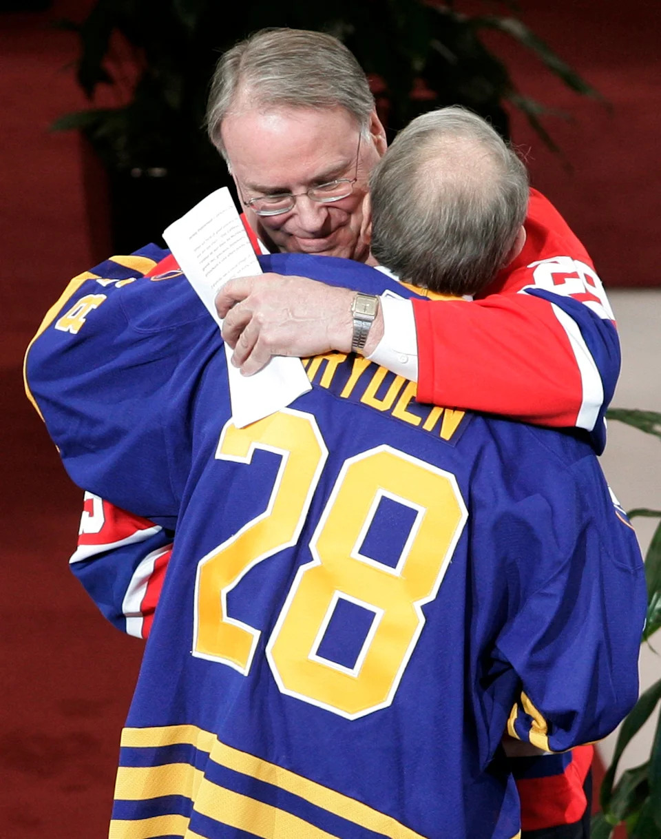 Former Montreal Canadiens goaltender Ken Dryden (top) hugs his brother Dave during a ceremony to retire his number "29" in Montreal.