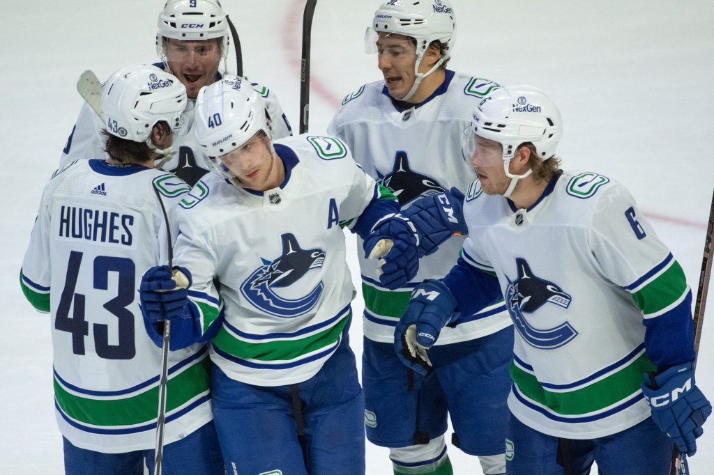 Vancouver Canucks players celebrating a goal.