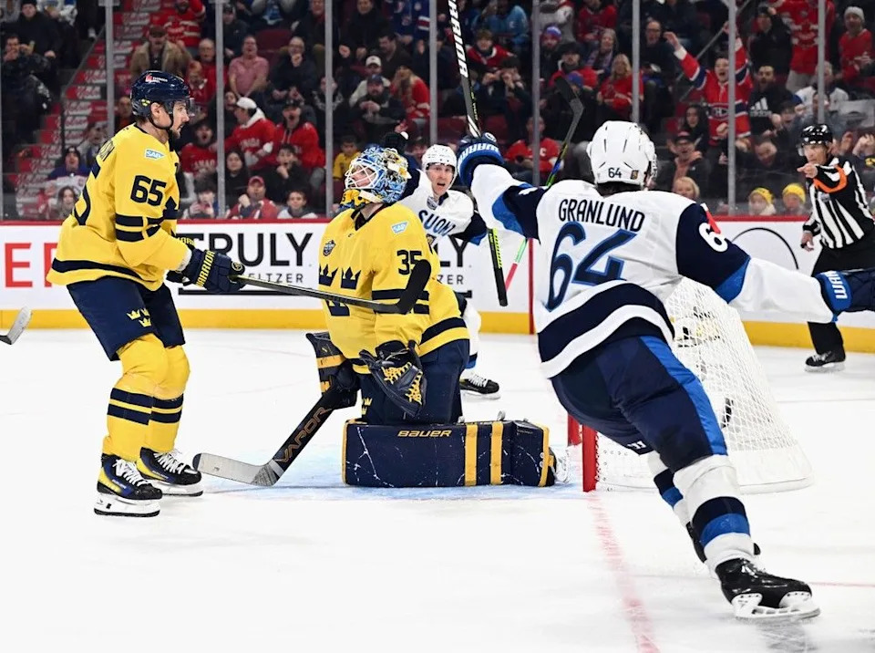 Mikael Granlund #64 of Team Finland (r) celebrates his game-winning overtime goal against Team Sweden in the 4 Nations Face-Off game at the Bell Centre on February 15, 2025 in Montreal, Quebec, Canada. Team Finland defeated Team Sweden 4-3 in overtime.