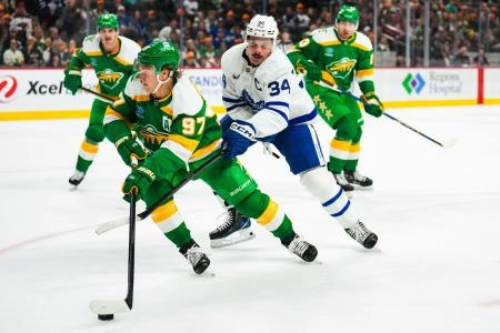 Minnesota Wild forward Kirill Kaprizov trying to evade Toronto Maple Leafs forward Auston Matthews.