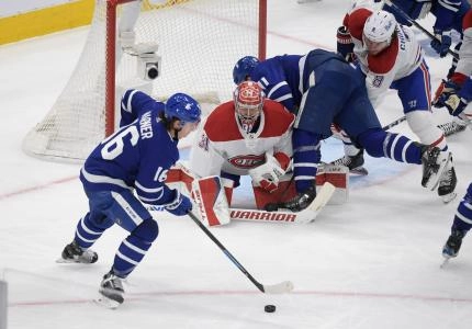 Toronto Maple Leafs forwards Mitch Marner and Zach Hyman press Montreal Canadiens goalie Carey Price