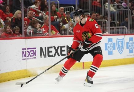 Chicago Blackhawks defenseman Sam Rinzel corralling a loose puck behind his own net. Chicago Blackhawks defenseman Sam Rinzel corralling a loose puck behind his own net.