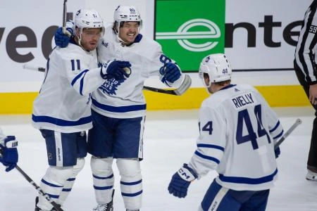 Feb 10, 2024; Ottawa, Ontario, CAN; Toronto Maple Leafs cente Max Domi (11) celebrates with left wing Nicholas Robertson (89) and defenseman Morgan Rielly (44) his goal scored in the third period against the Ottawa Senators at the Canadian Tire Centre. Mandatory Credit: Marc DesRosiers-Imagn Images