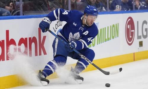 Mar 3, 2025; Toronto, Ontario, CAN; Toronto Maple Leafs defenceman Morgan Rielly (44) gets control of the puck against the San Jose Sharks during the second period at Scotiabank Arena