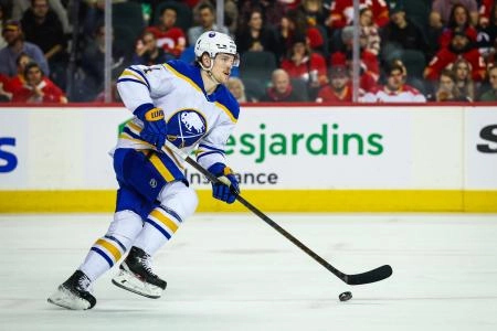 Jan 23, 2025; Calgary, Alberta, CAN; Buffalo Sabres defenseman Bowen Byram (4) skates with the puck against the Calgary Flames during the second period at Scotiabank Saddledome. Mandatory Credit: Sergei Belski-Imagn Images