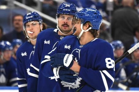 Dec 4, 2024; Toronto, Ontario, CAN; Toronto Maple Leafs forward Auston Matthews (34) speaks with forward William Nylander (88) as forward Matthew Knies (23) looks on in the first period against the Nashville Predators at Scotiabank Arena. Mandatory Credit: Dan Hamilton-Imagn Images