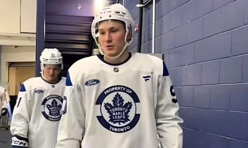 Former Toronto Maple Leafs prospect Reggie Newman wearing a Maple Leafs practice jersey while walking in the arena tunnel