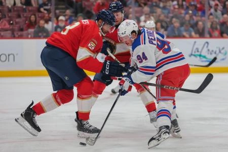 Apr 14, 2025; Sunrise, Florida, USA; New York Rangers right wing Gabe Perreault (94) moves the puck against Florida Panthers defenseman Seth Jones (3) during the first period at Amerant Bank Arena. Mandatory Credit: Sam Navarro-Imagn Images