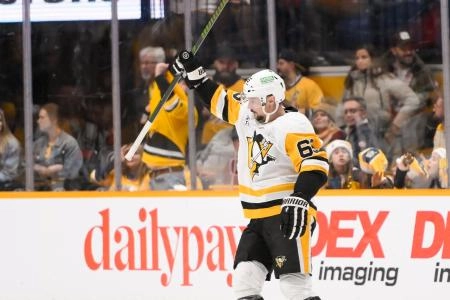 Dec 19, 2024; Nashville, Tennessee, USA; Pittsburgh Penguins defenseman Erik Karlsson (65) celebrates his goal against the Nashville Predators during the third period at Bridgestone Arena. Mandatory Credit: Steve Roberts-Imagn Images
