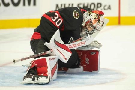 Sep 29, 2023; Ottawa, Ontario, CAN; Ottawa Senators goalie Kevin Mandolese (30) stretches after entering the game in the second period against the Winnipeg Jets at the Canadian Tire Centre. Mandatory Credit: Marc DesRosiers-Imagn Images