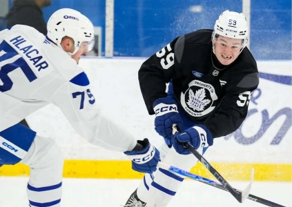 Maple Leafs prospects Matthew Hlacar and Blake Smith battle for the puck during rookie camp.