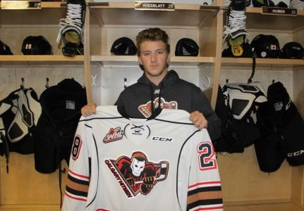 Orca Wiesblatt poses with a Calgary Hitmen jersey after signing with the WHL team Orca Wiesblatt poses with a Calgary Hitmen jersey after signing with the WHL team