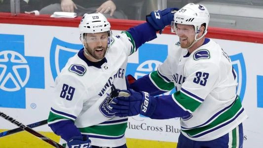 Former Vancouver Canucks forward Sam Gagner celebrating a goal with one of the team's all-time greats, Henrik Sedin.