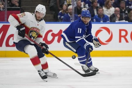 :May 14, 2025; Toronto, Ontario, CAN; Toronto Maple Leafs forward Max Domi (11) and Florida Panthers defenseman Dmitry Kulikov (7) battle for a loose puck during the first period of game five of the second round of the 2025 Stanley Cup Playoffs at Scotiabank Arena. Mandatory Credit: John E. Sokolowski-Imagn Images