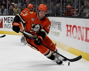 Dec 4, 2024; Anaheim, California, USA; Anaheim Ducks center Mason McTavish (23) controls the puck against the Vegas Golden Knights during the second period at Honda Center. Mandatory Credit: Alex Gallardo-Imagn Images