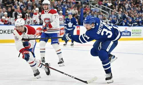 Oct 2, 2023; Toronto, Ontario, CAN; Toronto Maple Leafs forward Auston Matthews (34) shoots the puck past Montreal Canadiens defenseman Mattias Norlinder (59) in the third period at Scotiabank Arena