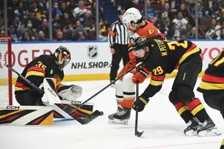 Vancouver Canucks goaltender Thatcher Demko (35) and defenseman Marcus Pettersson (29) defend against Anaheim Ducks forward Mason McTavish (23) during the third period at Rogers Arena.