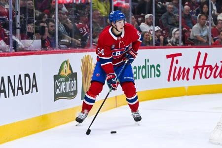 Sep 25, 2025; Montreal, Quebec, CAN; Montreal Canadiens defenseman David Reinbacher (64) considers his options with the puck against the Toronto Maple Leafs during the second period at Bell Centre. Mandatory Credit: David Kirouac-Imagn Images