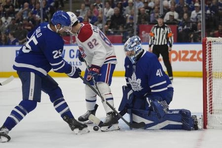 Sep 27, 2025; Toronto, Ontario, CAN; Toronto Maple Leafs goaltender Anthony Stolarz (41) makes a save as defenseman Brandon Carlo (25) helps out against the Montreal Canadiens during the second period at Scotiabank Arena. Mandatory Credit: John E. Sokolowski-Imagn Images