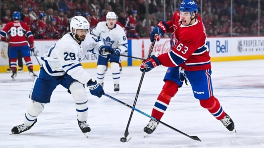 ep 25, 2025; Montreal, Quebec, CAN; Montreal Canadiens left wing Florian Xhekaj (63) shoots the puck beside Toronto Maple Leafs forward Bo Groulx (29) during the third period at Bell Centre. Mandatory Credit: David Kirouac-Imagn Images