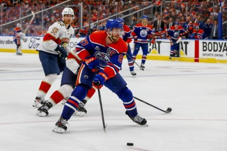 Jun 14, 2025; Edmonton, Alberta, CAN; Edmonton Oilers center Connor McDavid (97) controls the puck against Florida Panthers forward Aleksander Barkov (16) during the third period in game five of the 2025 Stanley Cup Final at Rogers Place. Mandatory Credit: Perry Nelson-Imagn Images
