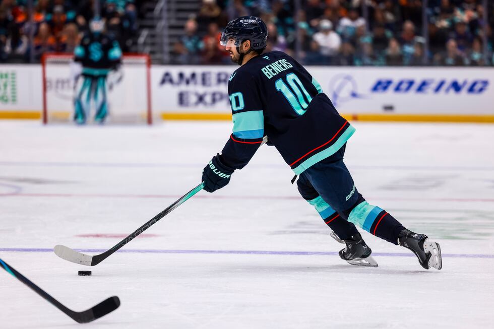 Seattle Kraken center Matty Beniers skates with the puck during an NHL hockey game against the...