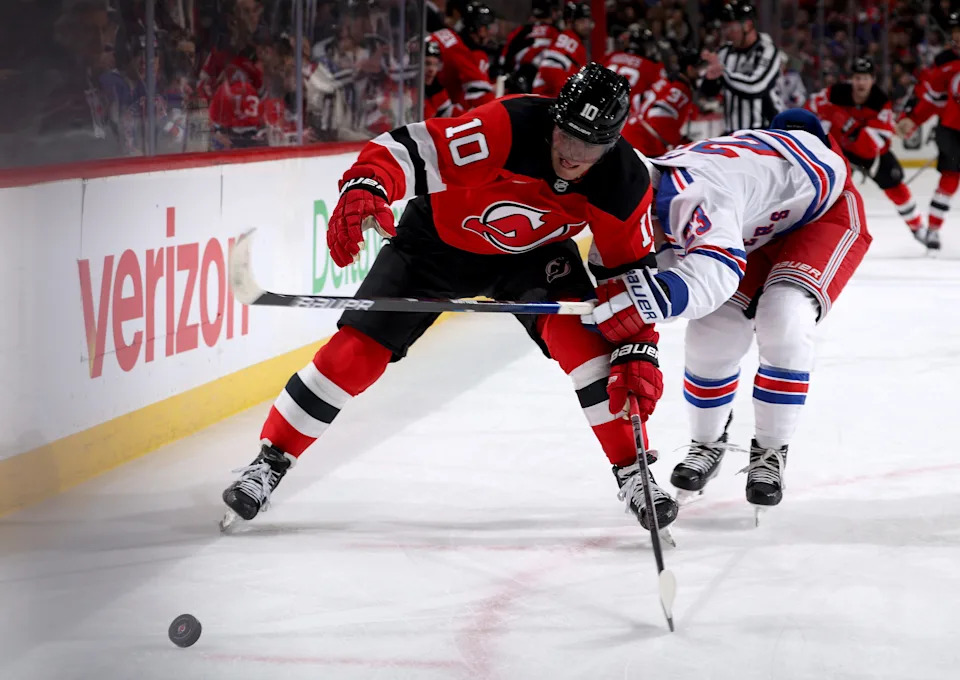 Daniel Sprong #10 of the New Jersey Devils steals the puck from Adam Fox #23 of the New York Rangers during the second period at Prudential Center on April 5, 2025 in Newark, New Jersey.