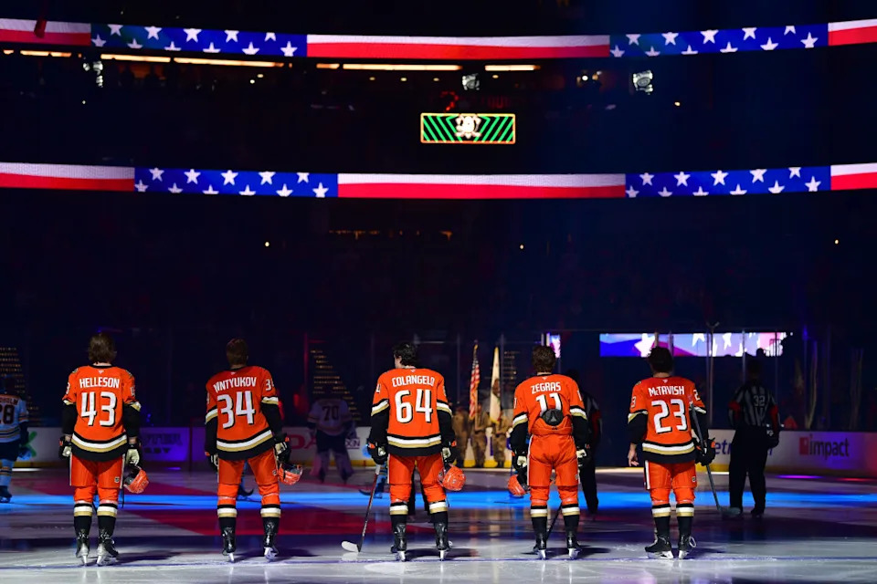 Anaheim Ducks players stand up during the national anthem before an NHL game.Gary A. Vasquez-Imagn Images