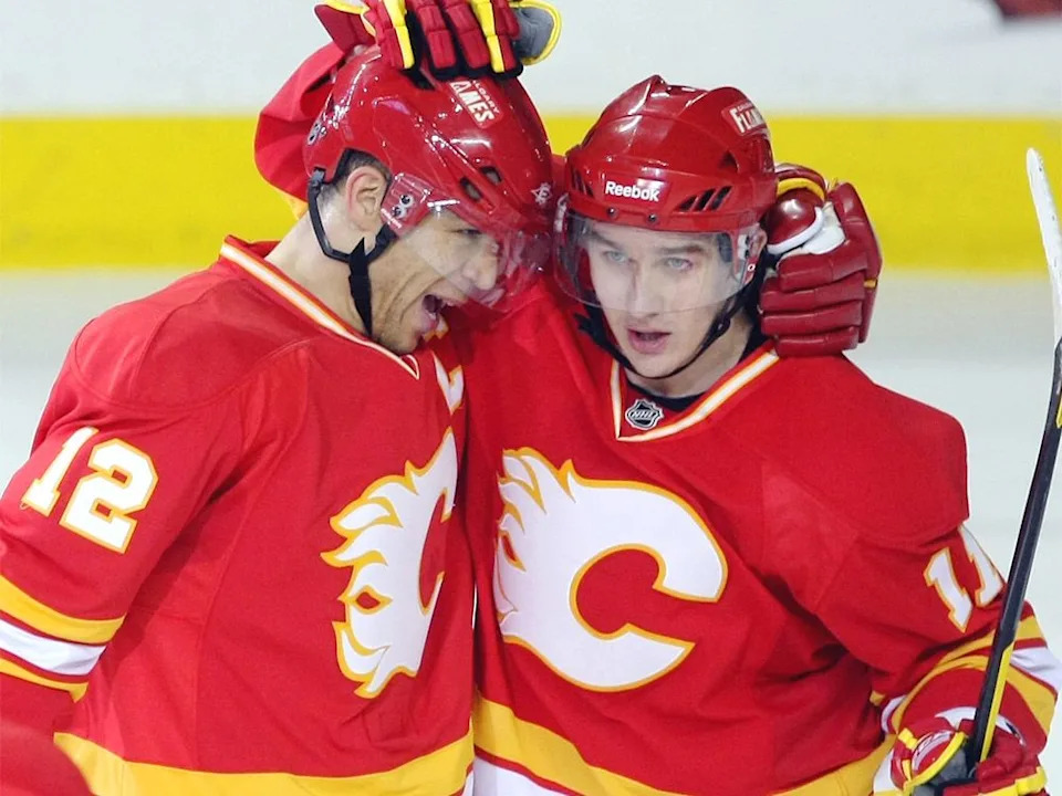 Calgary Flames right winger Jarome Iginla, left, gets congratulated by teammate centre Mikael Backlund after Iginla scored his 40th goal of the season against the Edmonton Oilers during second-period NHL action at the Scotiabank Saddledome on April 6, 2011.