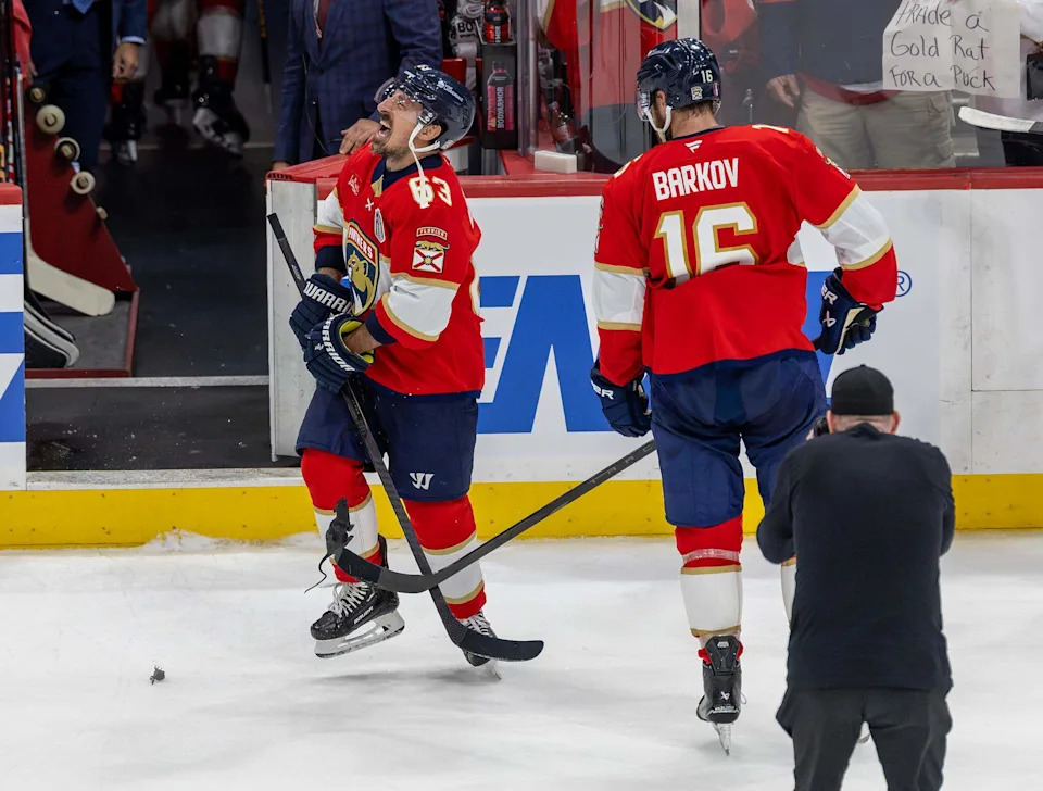 Florida Panthers center Brad Marchand (63) reacts as teammate Aleksander Barkov (16) hit him with plastic rats after their 6-1 victory over the Oilers in Game 3 of the NHL Stanley Cup Final at Amerant Bank Arena on Monday, June 9, 2025, in Sunrise, Fla.