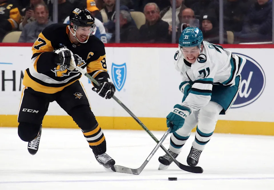 Pittsburgh Penguins center Sidney Crosby (87) and San Jose Sharks center Macklin Celebrini (71) battle to control the puck.Charles LeClaire-Imagn Images
