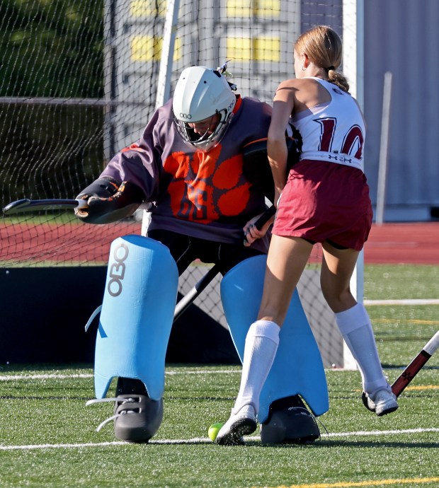 Gloucester's Fiona Black, right, crashes into Beverly goaltender Charlotte Stevens during field hockey action. Gloucester was a 3-0 winner. (Staff Photo By Stuart Cahill/Boston Herald)