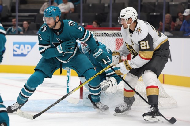 San Jose Sharks defenseman Vincent Desharnais (5) works against Vegas Golden Knights forward Brett Howden (21) during their game on Sunday, Sept. 21, 2025, in San Jose, Calif. (Aric Crabb/Bay Area News Group)