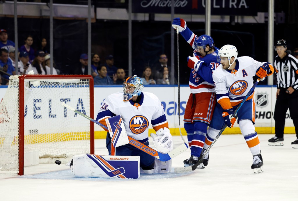 Brennan Othmann (center) celebrates after a first period goal by Vincent Trocheck (not pictured) during the Rangers' 5-4 preseason loss to the Islanders. Othmann scored a goal of his own later in the period.