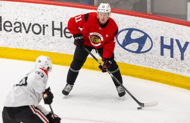Chicago Blackhawks center Oliver Moore passes the puck to a teammate during practice at the Fifth Third Arena in Chicago on Wednesday, Sept. 10, 2025. (Dominic Di Palermo/ Chicago Tribune)