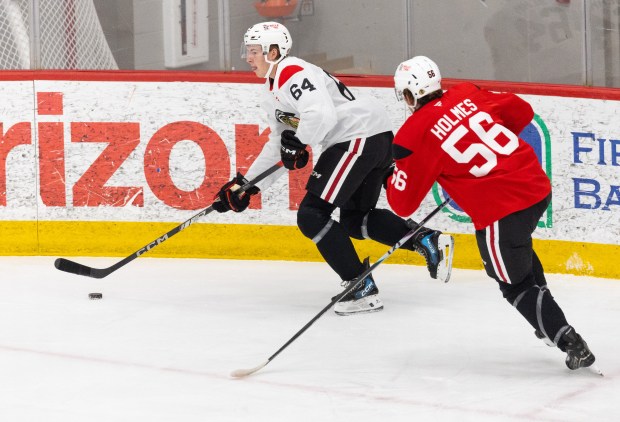 Chicago Blackhawks right wing Nathan Behm keeps the puck away from defenders during practice at the Fifth Third Arena in Chicago on Wednesday, Sept. 10, 2025. (Dominic Di Palermo/ Chicago Tribune)